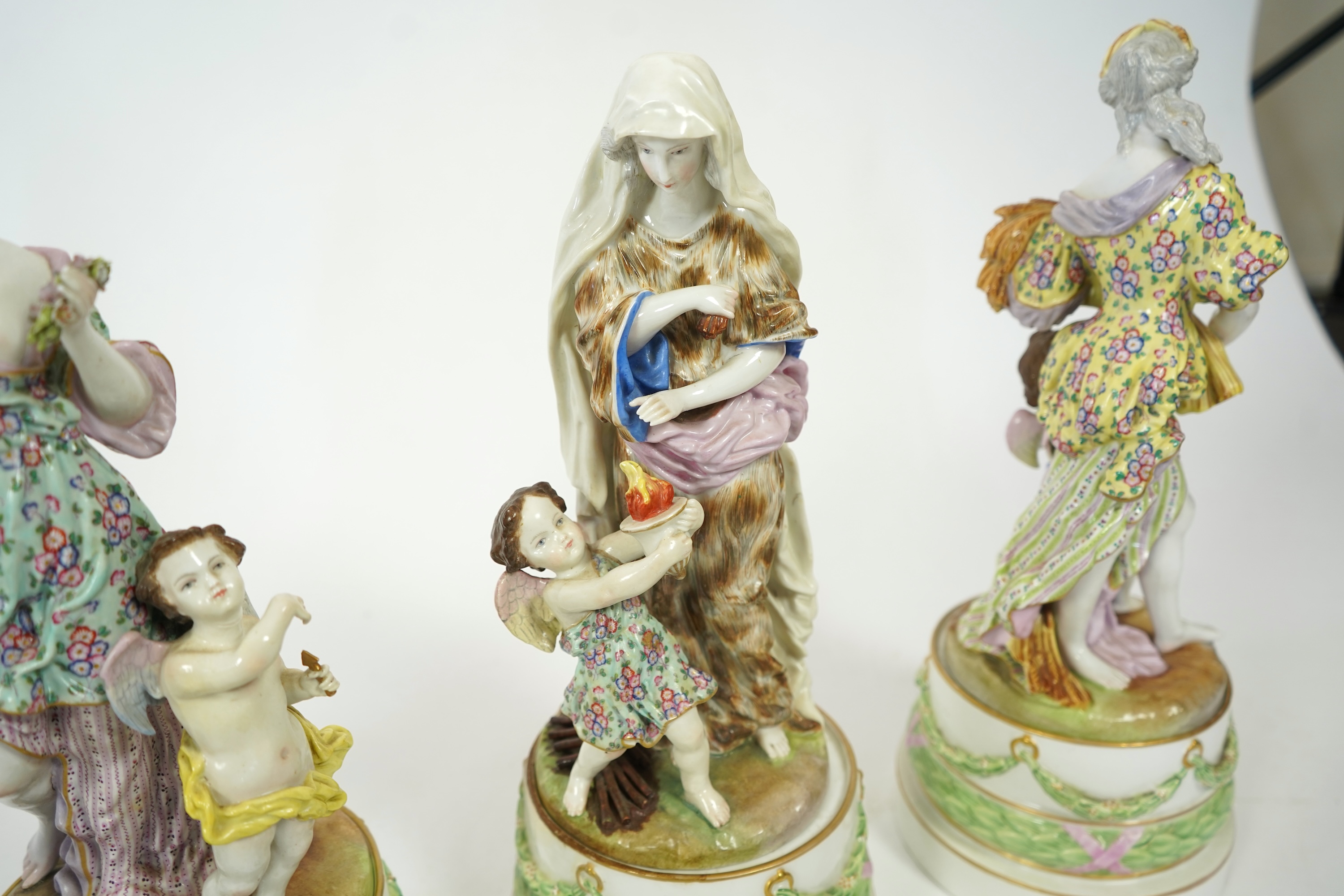 A set of four large Meissen style 'Four Seasons' groups and separate pedestals